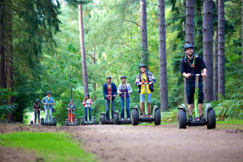 Group enjoying Segway tour through forest near Three Little Pigs hotel, Blandford Forum