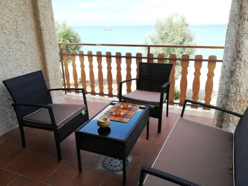 Terrazza sul mare della Noemi Holiday House con mobili in rattan nero e vista mare ad Agnone Bagni, Italia