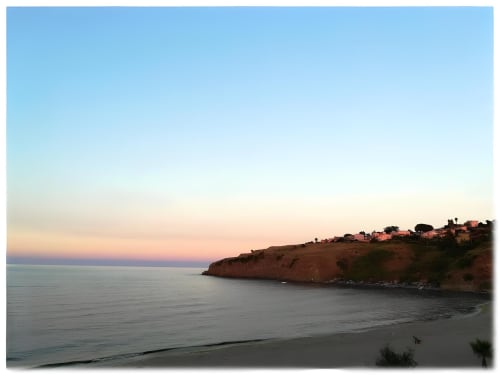 Sunset view of Agnone Bagni beach with rocky coastline and Mediterranean Sea at Noemi Holiday House