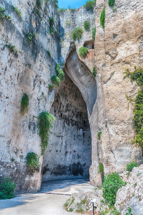 Ancient stone archway with ivy vines at Noemi Holiday House, Agnone Bagni Italy