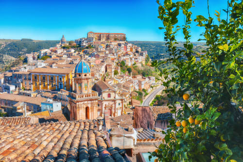 Colorful historic town of Modica with baroque church dome and terracotta roofs in Sicily, near Agnone Bagni