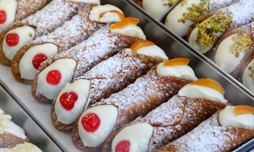 Chocolate eclairs with cream filling and red candies at Noemi Holiday House, Agnone Bagni