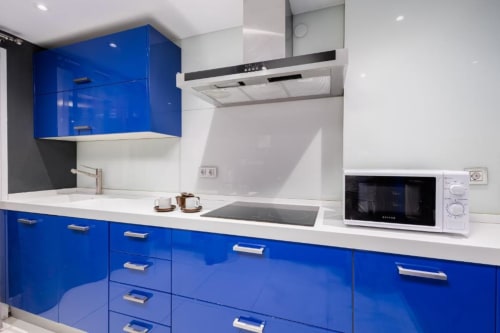 Modern blue and white kitchen in Tembo apartment, Puerto Banús, Marbella with microwave, dishwasher and built-in appliances