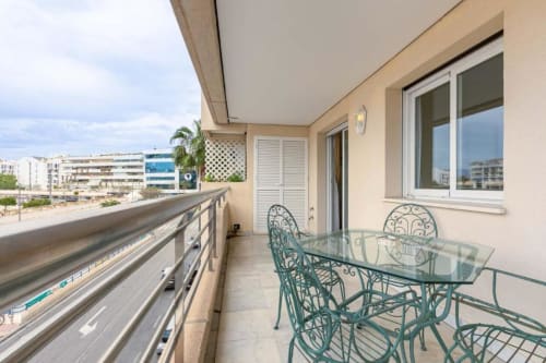 Balcony at Marbella Home Rentals Marina Banús apartment with city views, dining table, and modern furnishings