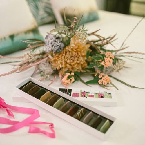 Romantic Paris B&B detail: floral arrangement with thread color palette and pink ribbon at Montmartre