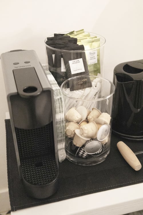 Coffee station with Dammann tea sachets, sugar cubes, and accessories at Montmartre Romantic B&B Paris
