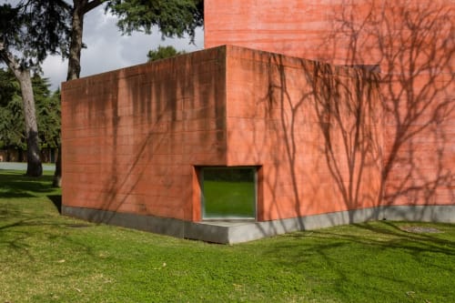 Modern red brick architectural structure at Embaixada da Vila boutique hotel in Cascais with tree shadows