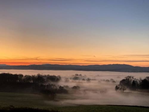 Misty valley sunrise over Château de Vaux Morvan in Étang sur Arroux, France