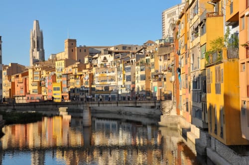 Colorful waterfront buildings reflected in river, Brides-les-Bains, France