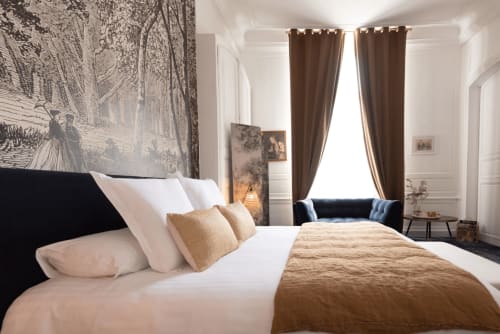 La Mademoiselle room at Henri II hotel in Le Mans features a luxury bed with garden views and brown curtains