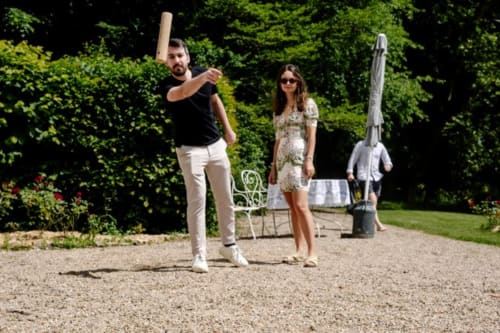 Guests playing baseball at Château de Vaux Morvan, a French bed and breakfast in Étang sur Arroux with lush green gardens.