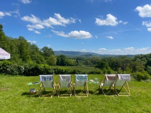 Deckchairs with laundry drying in green meadow at Château de Vaux Morvan, Étang sur Arroux