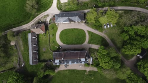 Vue aérienne du Château de Vaux Morvan avec ses jardins soignés, bâtiments et forêts environnantes à Étang sur Arroux