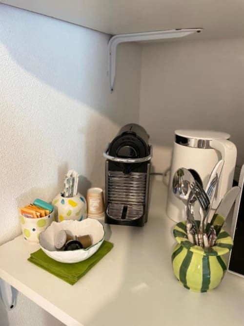 Coffee station in Wisteria Double Room at La Cascina di Bea with Nespresso machine, kettle, and green striped planter at