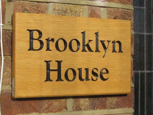 Brooklyn House wooden sign on brick wall, Southgate London bed and breakfast entrance