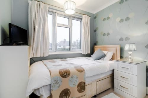Superior single room at Brooklyn House London with garden view, wooden bed, and modern furnishings