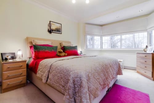 Spacious Deluxe King Room at Brooklyn House with queen bed, wooden furniture, garden views through bay windows, and modern