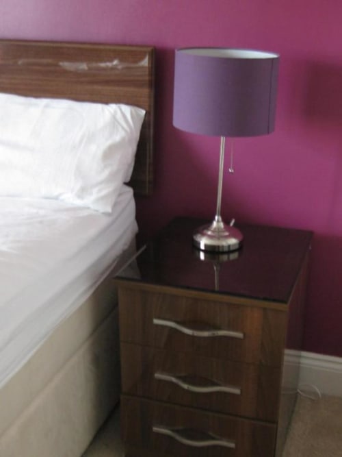 Bedside table with purple lamp in Superior King Room at Brooklyn House B&B, Southgate London