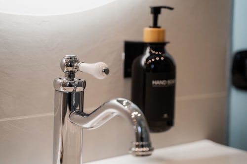 Rubinetto bagno cromato moderno con dispenser di sapone liquido a Villa Del Sole Inn di Campobasso