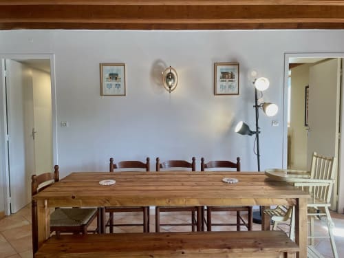 Château de Vaux Morvan dining room with wooden table, chairs, framed architectural prints, and pendant lighting in Étang sur