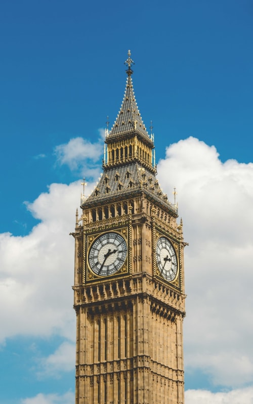 Big Ben clock tower against blue sky with clouds, London landmark near Brooklyn House Southgate