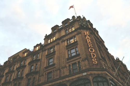 Historic Harrods building facade with red brick architecture and British flag in Southgate, London