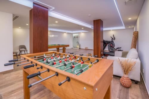 Moderna sala de jogos na villa Casa da Colina com pebolim, bilhar, bicicleta estacionária e área de estar