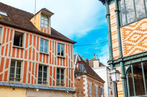 Bâtiment historique à colombages du Manoir Saint Joseph à Sens, France, avec façade aux rayures rouge et blanc, style traditionnel