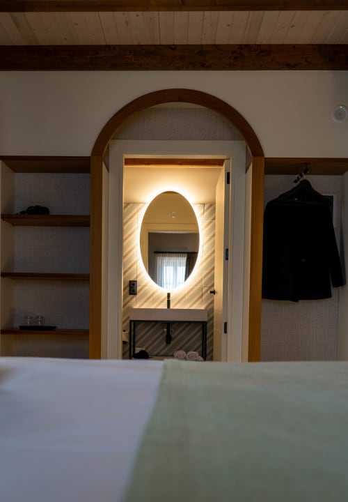 Baño moderno con espejo ovalado iluminado en Casa Rural San Andres de Teixido, Galicia, España