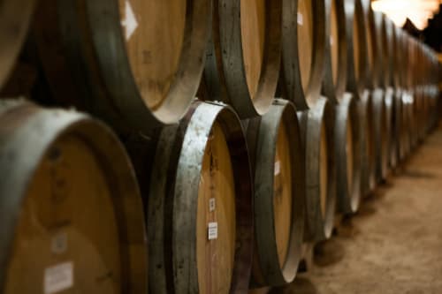 Wine barrels in a cellar at Recantus Comporta winery and hotel in Comporta, Portugal