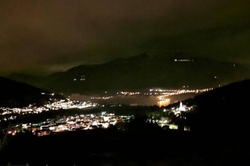 Vista notturna della Valle di Trento illuminata dal balcone dell'appartamento Maso Kreuzberg