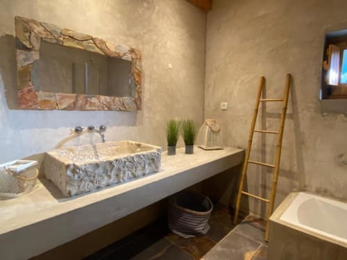 Luxury bathroom at Corvatos Casas do Monte villa with stone vessel sink, marble countertop, heated towel ladder, and modern