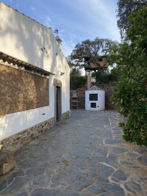 Courtyard at Corvatos Casas do Monte villa in Almodôvar with stone patio, white-washed buildings, and traditional