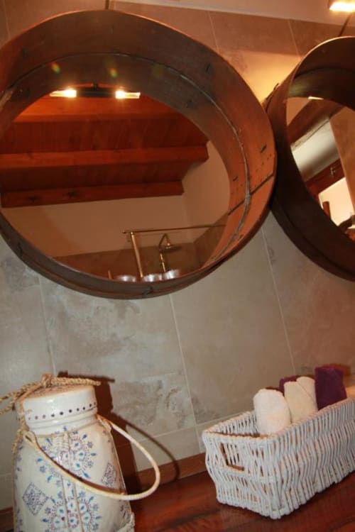 Bathroom mirrors and wicker baskets with toiletries at Corvatos Casas do Monte villa in Almodôvar, Portugal