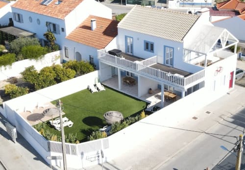 Aerial view of Recantus Comporta hotel with white villa, manicured garden, terrace, and red-tiled roofs in Comporta, Portugal