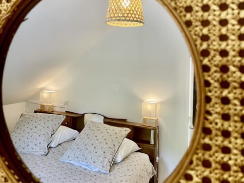 Bedroom at Château de Vaux Morvan B&B in Étang sur Arroux, twin beds with wooden headboard, woven pendant light, viewed