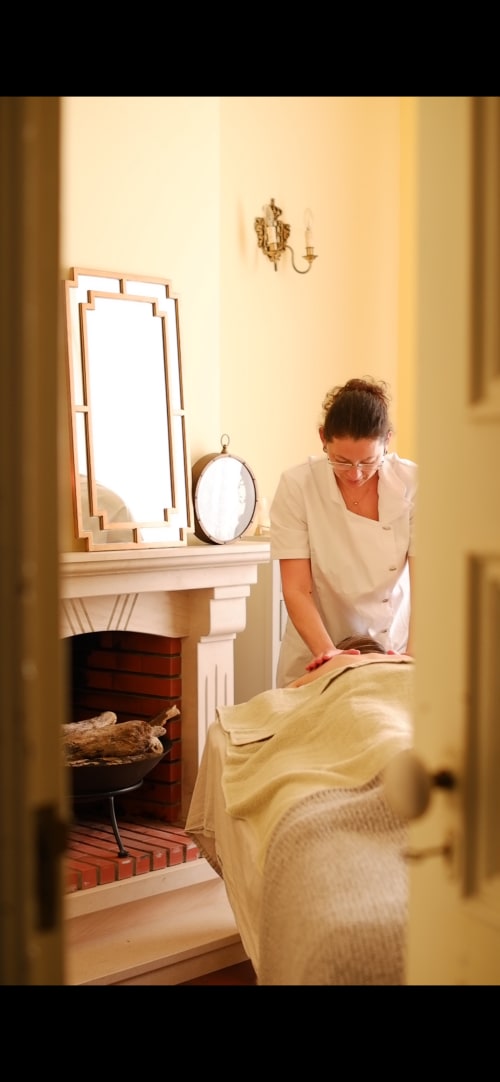 Spa therapist preparing massage bed at Villa Várzea boutique hotel in Portugal