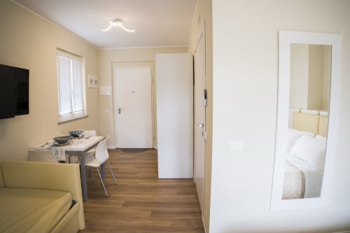 Modern studio apartment at Residence Balconi del Conero in Marcelli with kitchenette, dining area, and bedroom view