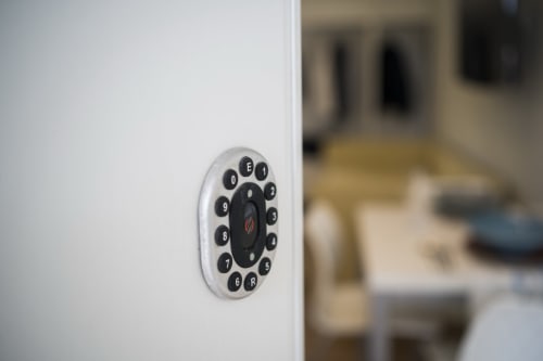 Smart home keypad control panel mounted on white wall at Residence Balconi del Conero apartment in Marcelli