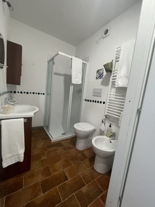 Modern bathroom at La Cascina di Bea with shower, toilet, bidet, and sink in Torre Boldone, Bergamo
