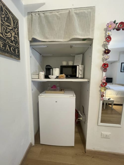 Compact kitchenette in Wisteria Double Room at La Cascina di Bea B&B with microwave, refrigerator, and coffee maker