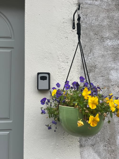 Hanging green planter with purple and yellow flowers at La Cascina di Bea, Bergamo