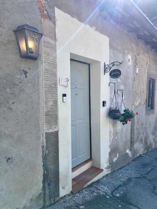 Charming entrance to Iris Double Room at La Cascina di Bea B&B in Torre Boldone, Bergamo, with light blue door and hanging