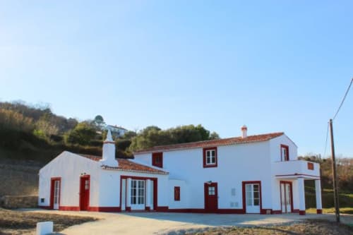Casas de Juromenha hotel with white walls and red trim, traditional Portuguese architecture in Juromenha