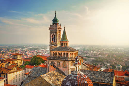 Bergamo's historic towers and terracotta rooftops with sprawling Italian cityscape, near La Cascina di Bea