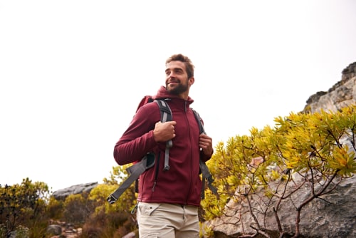 Hiker with backpack in Bergamo mountains near La Cascina di Bea, Torre Boldone
