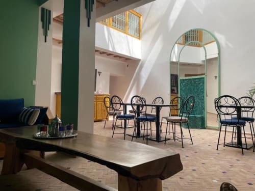 Riad Madinina courtyard lounge in Marrakech with decorative chairs, archways, and natural light