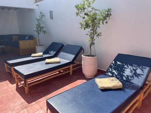 Spa treatment room at Riad Madinina with massage beds, olive tree plant, and traditional Moroccan architecture in Marrakech