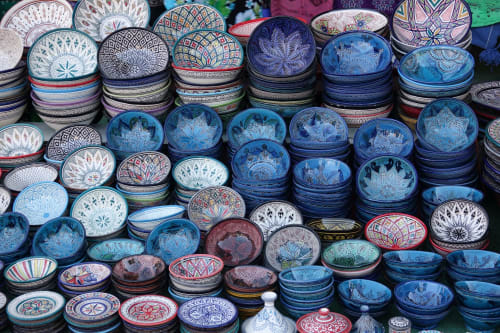 Colorful Moroccan ceramic bowls and tagines displayed at Riad Madinina market in Marrakech, Morocco