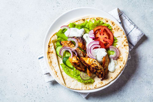 Grilled chicken wrap with fresh lettuce, tomato, cucumber, red onion and white sauce at Brooklyn House, Southgate London